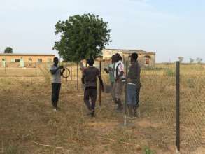 Volunteers fence the new site in Back Samba Dior