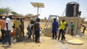 Community members & CREATE! staff install the pump