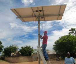 Installing the solar panel with local volunteers