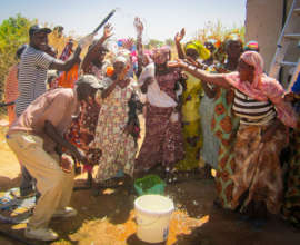 Community members in Santhie celebrating water