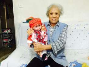 Old man holding a doll