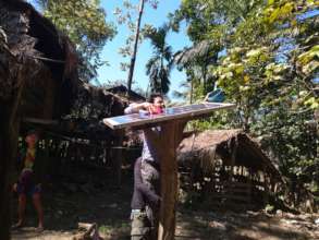 Villagers cleaning solar panel