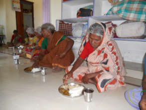 Poor elderly persons in old age home getting food