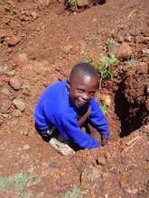 Child Planting a Tree at Kangeme Youth Centre