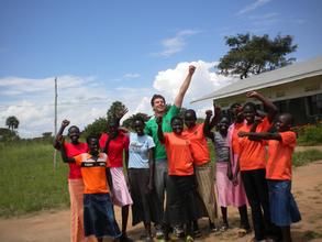 Colin and NESEI girls are excited on "Plant A Tree in Yei Day."