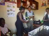 A woman beneficiary receives hair salon inputs
