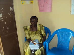 OVC Care giver after receiving books & pens