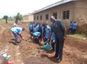 The Principal at Babessi Secondary School helping