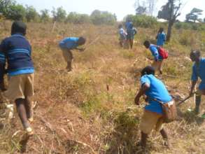 Children learning to prepare the soil