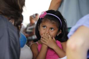 Shy but trusting; a little girl talks to our docs