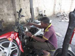 Auwal's Employee Working on Motorcycle Repair