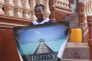 Dorcas holding a Poster about Destiny