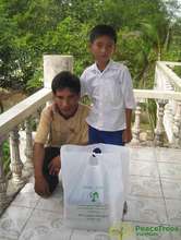 A father and son pose with a scholarship package