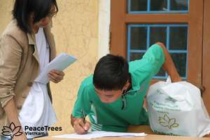 A student officially signs up for his scholarship