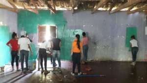 College students painting rural schools