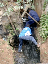 Taka ni Pato members unclog a drainage pipe
