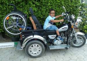 Mo Posing on his Dad's Tricycle