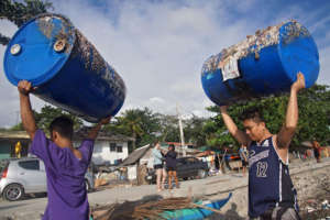 Hauling off blue barrels that once were tied.