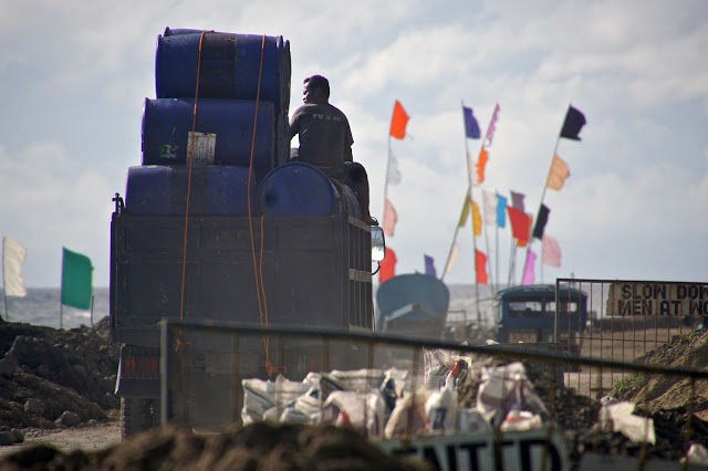 The university workers hauled away the barrels.