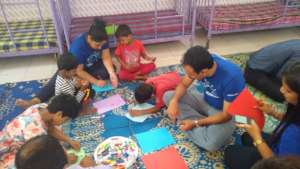 Volunteers helping the children
