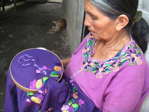 Clara embroidering a blouse.