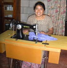 Nicolas Sewing on her microloan financed machine