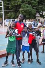 Coach Sani with winning kids from GSS Minna court.
