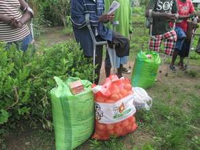 Amputees recieving the food items