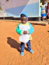 Pre-school children receive mosquito nets