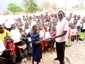 MUCHAMBILA PUPILS RECEIVING MOSQUITO NETS