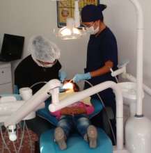 Adela helping patient with worn shoes