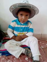 Bolivian boy in large hat at clinic