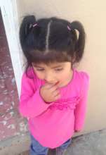 Bolivian girl in pink with pigtails