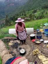 Highlands woman cooking with basic supplies