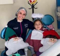 Dr. Frias with patient and Santas