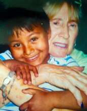 Sandy's Mother Eddie embracing Bolivian child