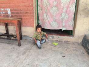 Child beside school wall