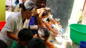 School children learning to brush their teeth