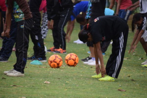Girls participating in football coach's training