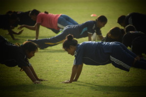 Girls participating in football coach's training