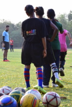 Girls participating in football coach's training