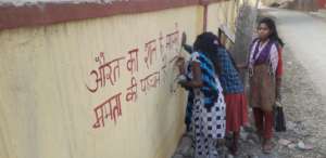 Women writing a pro-menstruation slogan