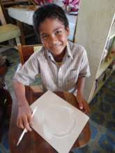 Primary school student crafting a Hicatee puppet