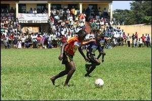 A girl challenging boysin a football match in Gulu