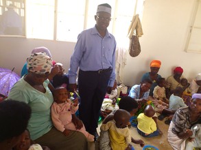Women & their kids enjoying the meal they prepared