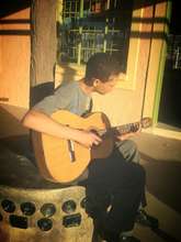 Lorenzo learning to play the guitar