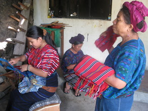 Estela on the ergonomic bench, weaving