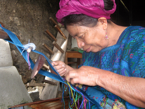 Doña Maria, weaving with eyes close to her work