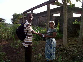 Farmer receiving seeds from project partner.