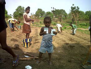 Child with seeds in garden, Liberia.